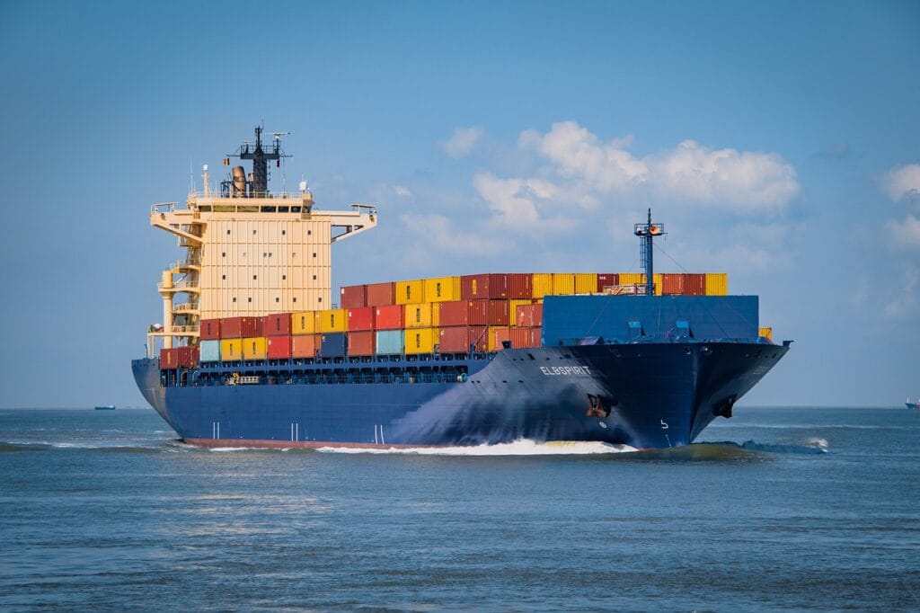 Cargo ship sailing with stacked containers